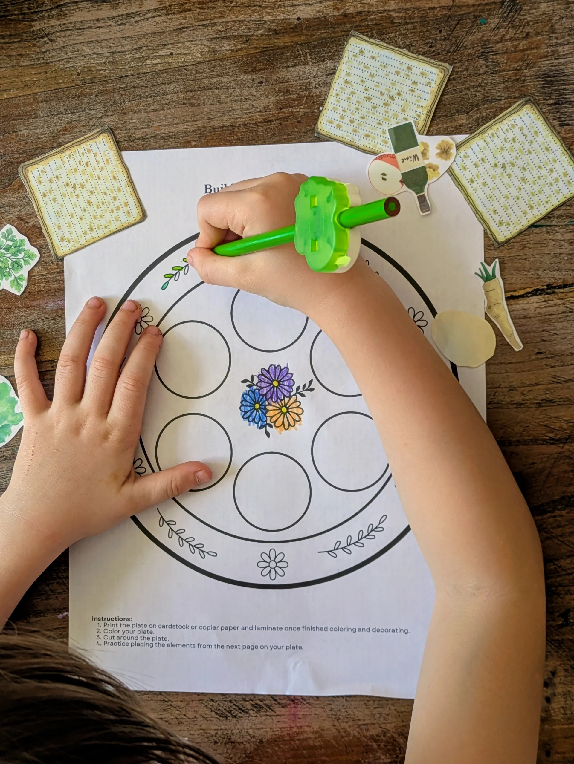 Kids coloring and assembling the printable seder plate craft